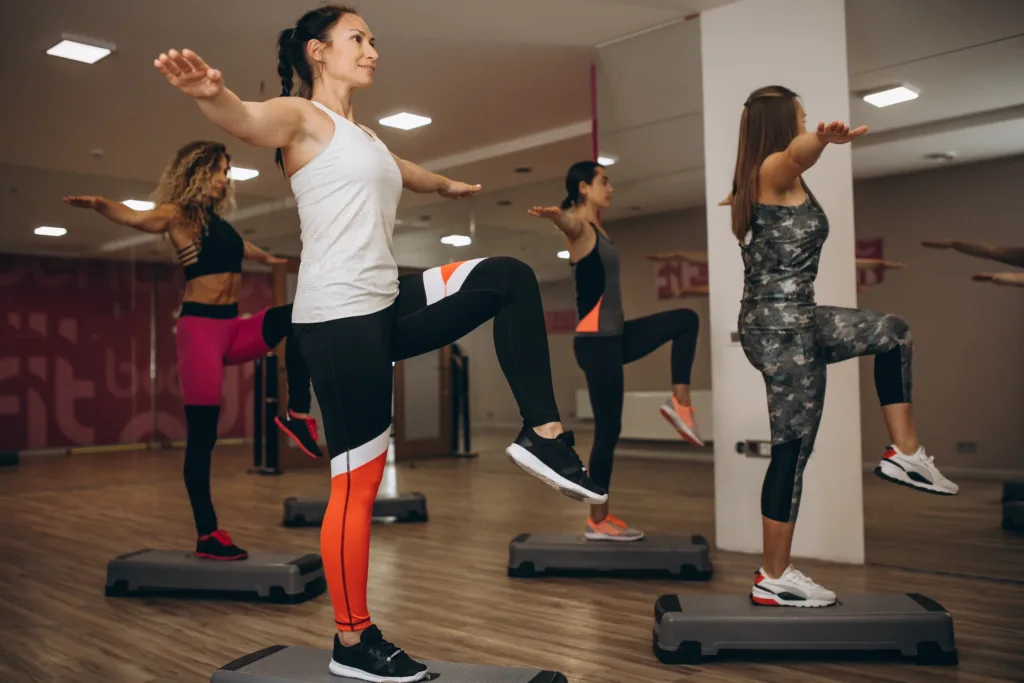 Pilates group working out in a gym
