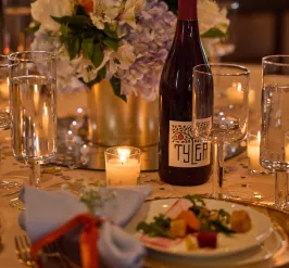 reaching for stars table setting with wine and a salad