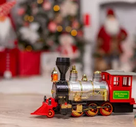 train in front of a christmas tree
