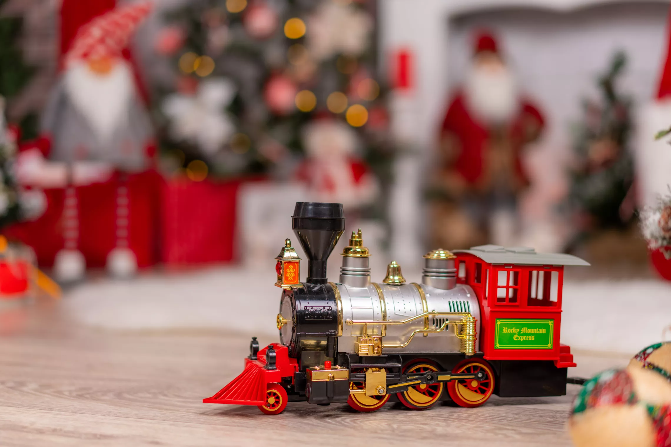 train in front of a christmas tree